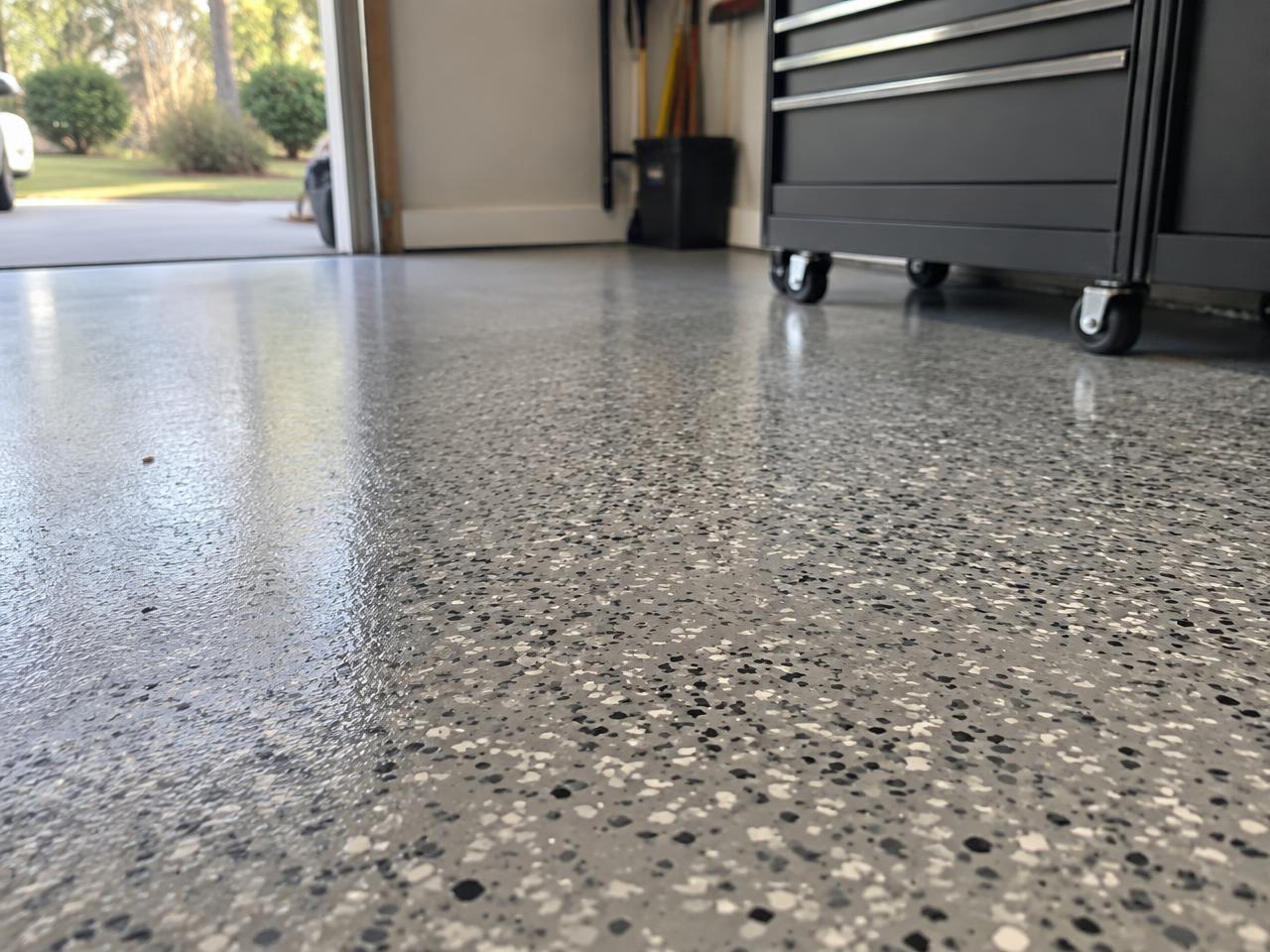 Close-up of a gray and black flake coated garage floor